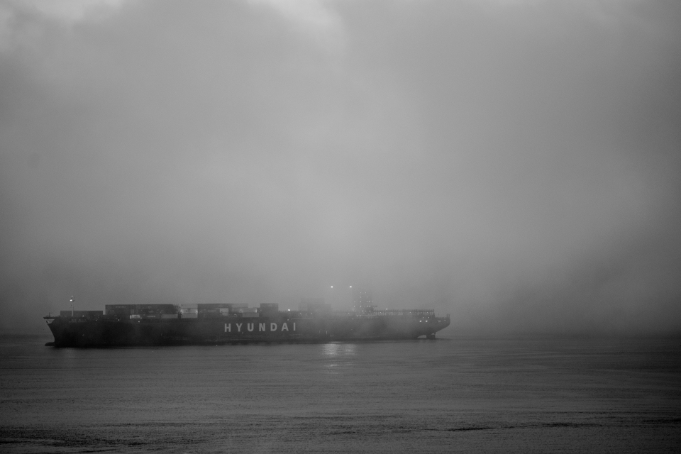 A freighter, coming into the Seattle shoreline. 